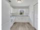 Clean kitchen featuring white cabinets, modern appliances, and a window at 1406 Sean Ct, St Cloud, FL 34772