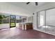 This enclosed patio features a hot tub, a ceiling fan, and a sliding glass door at 1406 Sean Ct, St Cloud, FL 34772
