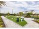 Outdoor community area featuring seating, landscaping, and a corn hole game at 1508 Stonecliff Dr, Apopka, FL 32703