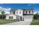 Modern two-story home featuring a two-car garage, paver driveway, and beautiful landscaping at 1508 Stonecliff Dr, Apopka, FL 32703