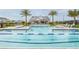 Beautiful community pool with clear blue water, palm trees, and ample seating for residents at 1515 Stonecliff Dr, Apopka, FL 32703