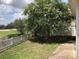 Enjoy golf course views from the private backyard, landscaped with mature trees at 1524 Conway Ct, The Villages, FL 32162