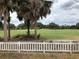 Desirable backyard view overlooking the golf course and mature landscaping at 1524 Conway Ct, The Villages, FL 32162