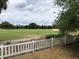 Lush backyard view overlooking the golf course and mature trees at 1524 Conway Ct, The Villages, FL 32162