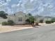 Well-maintained single-story home with neutral colors, complemented by lush landscaping at 1524 Conway Ct, The Villages, FL 32162