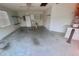 Large garage featuring a sink, storage shelves, and a door to the home's interior at 1524 Conway Ct, The Villages, FL 32162