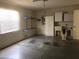 Functional garage with cabinets, utility sink, storage shelves and a rolling garage door at 1524 Conway Ct, The Villages, FL 32162