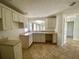 Open kitchen with a neutral color palette, white cabinets, and tile floors at 1524 Conway Ct, The Villages, FL 32162