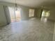 Spacious living room with wood-look floors, an adjacent screened lanai, and ample natural light at 1524 Conway Ct, The Villages, FL 32162