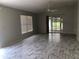 Large living room featuring wood-look floors, natural light, and an open layout at 1524 Conway Ct, The Villages, FL 32162