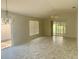 Spacious living room featuring wood-look floors, abundant natural light, and a ceiling fan at 1524 Conway Ct, The Villages, FL 32162
