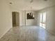 Bright living room with wood-look floors, neutral paint, and slider door access at 1524 Conway Ct, The Villages, FL 32162