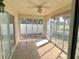 Enclosed sunroom with tiled floors and sliding glass doors to enjoy the outdoors at 1524 Conway Ct, The Villages, FL 32162