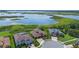 Stunning aerial view of waterfront homes in a cul-de-sac neighborhood with lush greenery and lake views at 15344 Johns Lake Pointe Blvd, Winter Garden, FL 34787