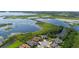 Aerial view of well manicured homes overlooking a beautiful lake with lush greenery in a peaceful community at 15344 Johns Lake Pointe Blvd, Winter Garden, FL 34787