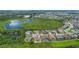 Aerial shot featuring a home's backyard and its placement in a vibrant neighborhood, surrounded by nature and a serene lake at 15344 Johns Lake Pointe Blvd, Winter Garden, FL 34787