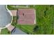 This aerial showcases the red roof, manicured lawn, and surrounding landscaping of the beautiful property at 15344 Johns Lake Pointe Blvd, Winter Garden, FL 34787