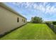 Green backyard with black fence overlooking lake at 15344 Johns Lake Pointe Blvd, Winter Garden, FL 34787