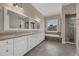 Luxurious bathroom featuring double vanity, soaking tub, and tiled shower at 15344 Johns Lake Pointe Blvd, Winter Garden, FL 34787