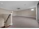 An upstairs bonus room with carpet, a ceiling fan, lots of natural light, and a view of the staircase at 15344 Johns Lake Pointe Blvd, Winter Garden, FL 34787