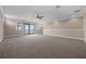Upstairs bonus room featuring neutral carpet, recessed lighting, with large windows and a sliding glass door to a balcony at 15344 Johns Lake Pointe Blvd, Winter Garden, FL 34787