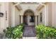 Inviting front entrance with a covered porch, columns, and beautiful landscaping at 15344 Johns Lake Pointe Blvd, Winter Garden, FL 34787