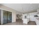 Kitchen with a center island, white cabinets, stainless steel appliances, and patio access at 15344 Johns Lake Pointe Blvd, Winter Garden, FL 34787