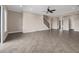Spacious living room featuring an open floor plan, tile flooring, staircase, and large columns, with a ceiling fan at 15344 Johns Lake Pointe Blvd, Winter Garden, FL 34787