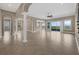 Spacious living room featuring elegant columns, tile floors, and sliding glass doors to a balcony with nice views at 15344 Johns Lake Pointe Blvd, Winter Garden, FL 34787