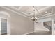 Elegant living space features coffered ceilings, chandelier, and staircase at 15344 Johns Lake Pointe Blvd, Winter Garden, FL 34787