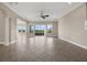 Bright and airy living room features tile floors and glass sliding doors overlooking a water view at 15344 Johns Lake Pointe Blvd, Winter Garden, FL 34787