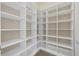 Walk-in pantry with extensive white shelving provides ample storage in this home at 15344 Johns Lake Pointe Blvd, Winter Garden, FL 34787