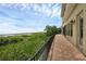 Brick paved patio with black railing, overlooking natural landscape and lake views at 15344 Johns Lake Pointe Blvd, Winter Garden, FL 34787