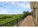 Brick paved patio with black railing, overlooking natural landscape and lake views at 15344 Johns Lake Pointe Blvd, Winter Garden, FL 34787