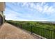 Long patio with brick pavers, black railing, and serene lake views at 15344 Johns Lake Pointe Blvd, Winter Garden, FL 34787
