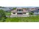 The back of the property has a covered patio with a well maintained lawn and lush foliage behind it at 15344 Johns Lake Pointe Blvd, Winter Garden, FL 34787