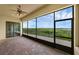 Spacious screened porch leads to an outdoor area with serene lake views at 15344 Johns Lake Pointe Blvd, Winter Garden, FL 34787