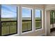 Large sun room windows offer panoramic views of the lake and surrounding greenery at 15344 Johns Lake Pointe Blvd, Winter Garden, FL 34787