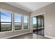 Bright sun room with scenic views from large windows and access to an outdoor patio at 15344 Johns Lake Pointe Blvd, Winter Garden, FL 34787