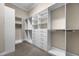 Custom walk-in closet with built-in shelving, drawers, and ample storage space at 15344 Johns Lake Pointe Blvd, Winter Garden, FL 34787