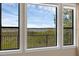 Scenic exterior view from a home window featuring lake and lush landscape at 15344 Johns Lake Pointe Blvd, Winter Garden, FL 34787