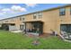 Townhome backyard with a screened patio and lush grassy area, perfect for outdoor enjoyment at 1575 Downy Birch Ln, Longwood, FL 32750
