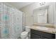 Bathroom featuring a shower with printed curtain and a sink, a well-lit functional space at 1575 Downy Birch Ln, Longwood, FL 32750