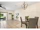 Well-lit dining area featuring a modern chandelier, sliding door to patio, and seating for four at 1575 Downy Birch Ln, Longwood, FL 32750