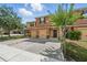 Inviting townhome featuring a well-maintained, colorful exterior and paver driveway at 1575 Downy Birch Ln, Longwood, FL 32750