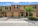 Inviting townhome featuring a well-maintained, colorful exterior and paver driveway at 1575 Downy Birch Ln, Longwood, FL 32750