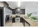 Modern kitchen featuring stainless steel appliances and granite countertops at 1575 Downy Birch Ln, Longwood, FL 32750