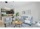 Open-concept living room with a gray sofa, stylish rug, and a view into the kitchen, ideal for modern living at 1575 Downy Birch Ln, Longwood, FL 32750