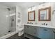 Modern bathroom featuring double sink vanity, framed mirrors, and glass-enclosed shower for a spa-like experience at 1575 Downy Birch Ln, Longwood, FL 32750