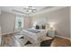 Elegant main bedroom with tray ceiling, laminate flooring, and soft, neutral colors for a serene retreat at 1575 Downy Birch Ln, Longwood, FL 32750